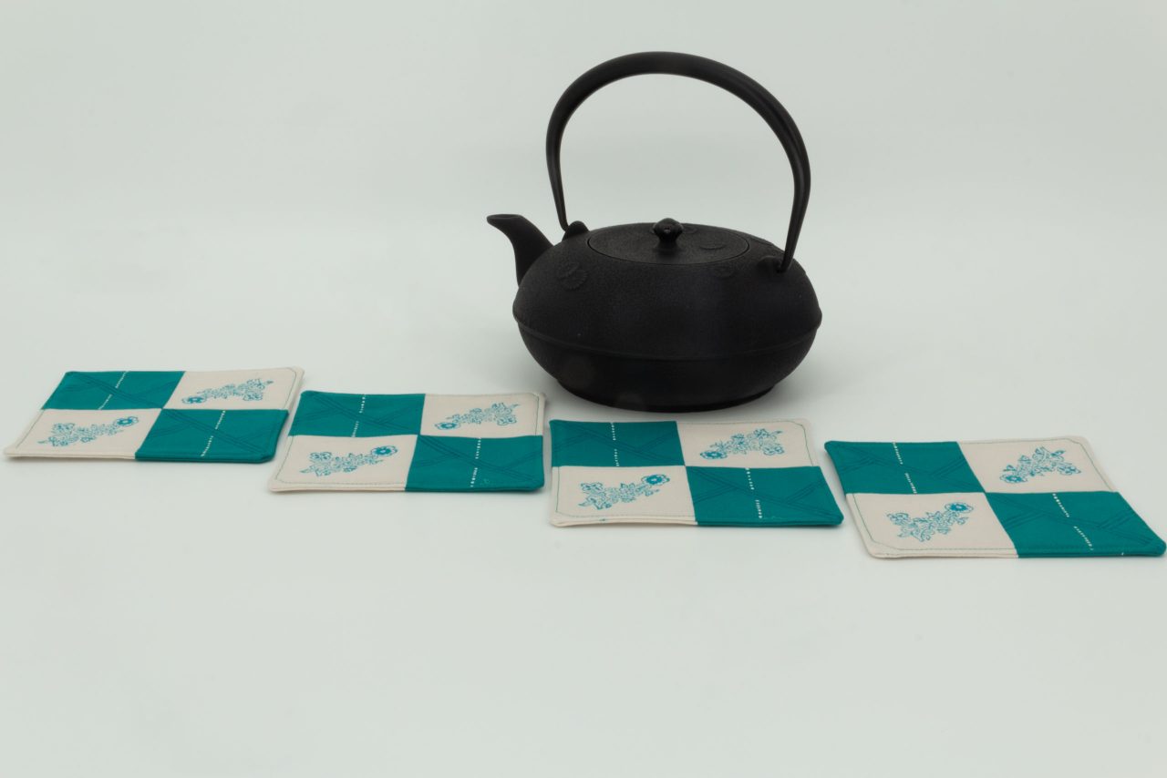 Four coasters and a cast iron kettle