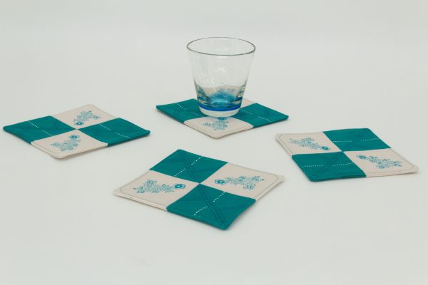 Four coasters and a glass